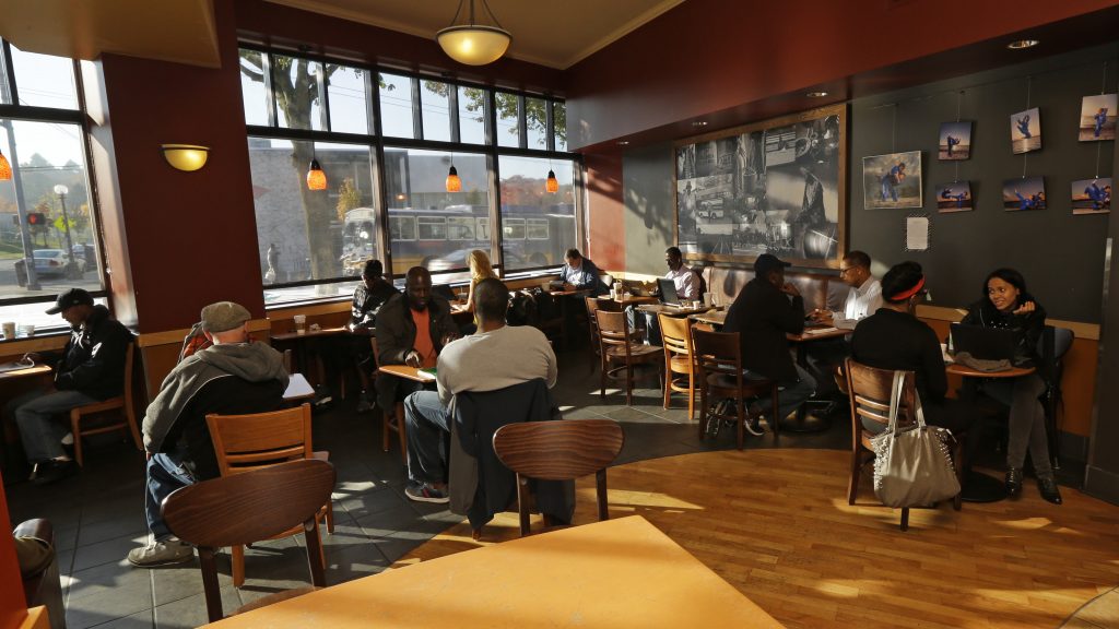 Customers sit in a Starbucks store in Seattle. Customers sit in a Starbucks store in Seattle.
(Ted S. Warren/AP)