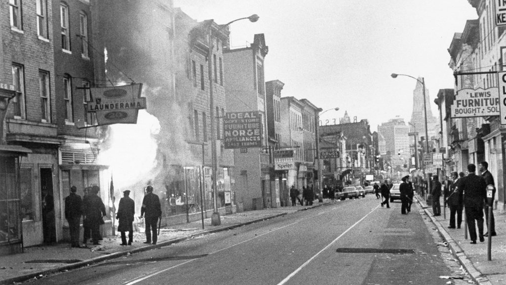 Fire shoots out from a Baltimore store on Gay Street as looting erupted in a five-block business section in Baltimore on April 6, 1968. Police sealed off the area. Fire shoots out from a Baltimore store on Gay Street as looting erupted in a five-block business section in Baltimore on April 6, 1968. Police sealed off the area. (AP)
