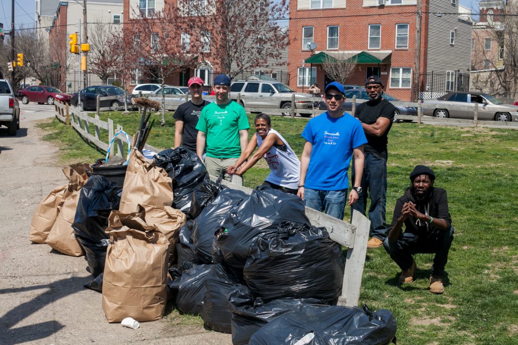 francisville-neighborhood-development-corporation-executive-director-penny-giles-pictured-with-her-cleanup-crew-at-a-spring-cleanup-sponsored-by-her-organization-brad-larrison-for-whyy-1.original People cleaning up a park with trashbags.