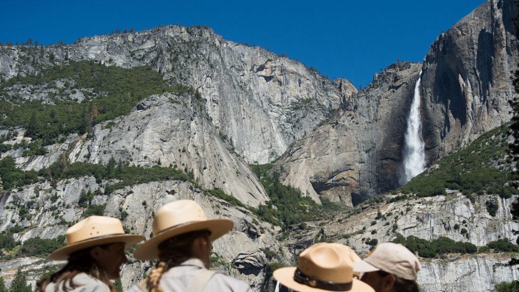 Park rangers meet in front of Yosemite Falls in 2016 in Yosemite National Park in California. Increased fees are expected to boost funding for park maintenance across the country. Park rangers meet in front of Yosemite Falls in 2016 in Yosemite National Park in California. Increased fees are expected to boost funding for park maintenance across the country. (David Calvert/Getty Images)