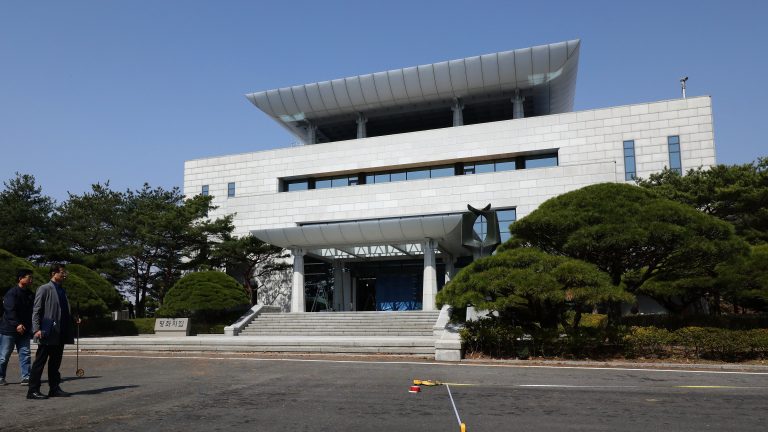 South Korean officials prepare for inter-Korean summit in front of the Peace House. Kim Jong Un and Moon Jae-in are scheduled to meet there Friday. (Chung Sung-Jun/Getty Images)
