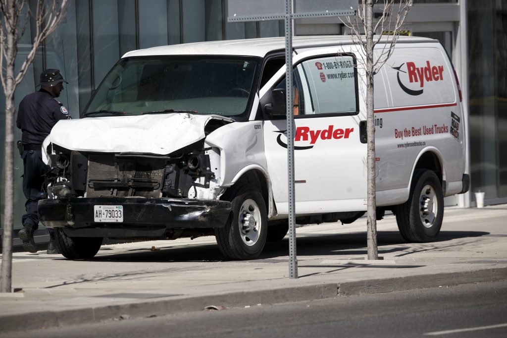 Police inspect a van suspected of being involved in a collision that killed at least nine people and injured 16 others in Toronto on Monday. Police inspect a van suspected of being involved in a collision that killed at least 10 people and injured 15 others in Toronto on Monday. (Cole Burston/Getty Images)