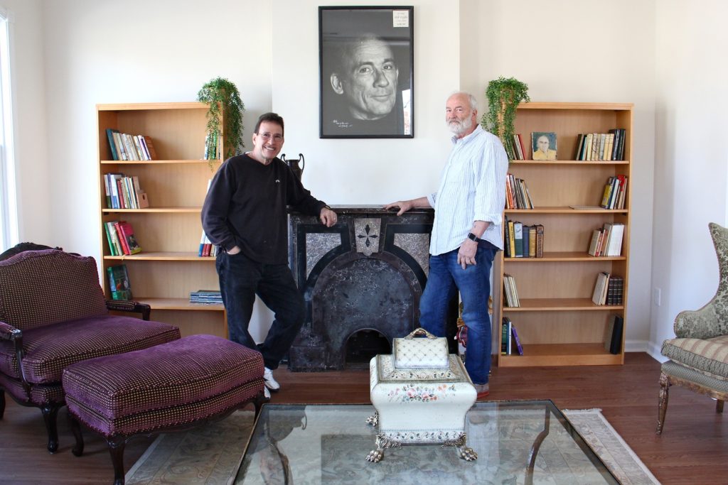 lead2018 04 23-e lee-george vallianos henry brann-camden-nick virgilio writers house George Vallianos (left), president of the Nick Virgilio Haiku Association, and board member Henry Brann, stand beneath a portrait of the poet at the Nick Virgilio Writers House in Camden.