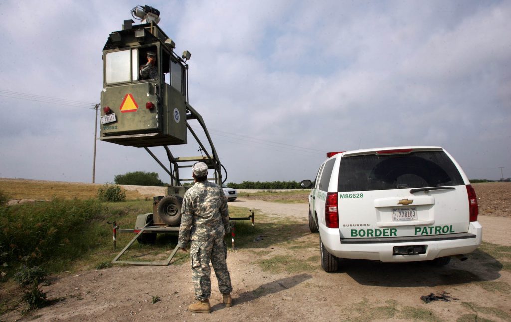 A member of the National Guard checks on his colleague inside a Border Patrol Skybox near the U.S.-Mexico border in Hidalgo, Texas, in this 2011 photo. President Trump is calling for troops on the southern border, something the last five presidents have all done. A member of the National Guard checks on his colleague inside a Border Patrol Skybox near the U.S.-Mexico border in Hidalgo, Texas, in this 2011 photo. President Trump is calling for troops on the southern border, something the last five presidents have all done.
(Delcia Lopez/AP)