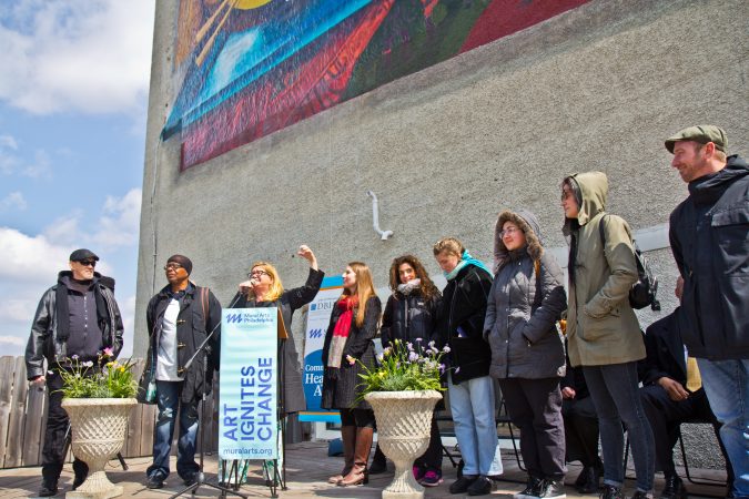 “Rippling Moon” lead artist Meg Saligman acknowledges the team of artists that executed the design and installation of the mural. (Kimberly Paynter/WHYY)