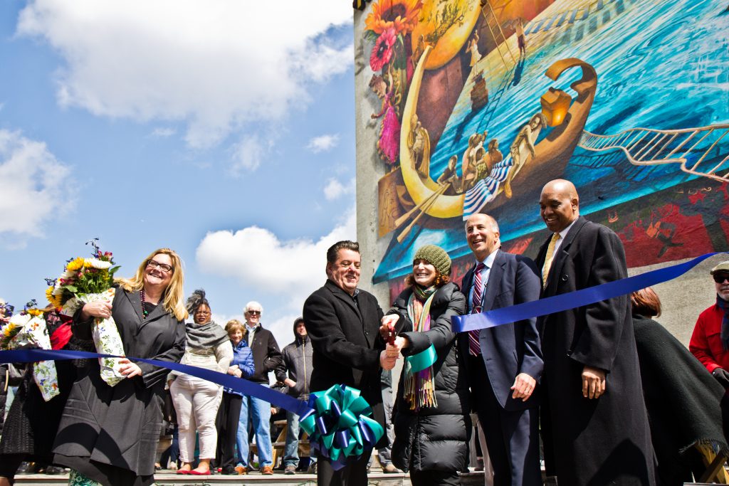 rippling moon-4 (From left) Artist Meg Saligman, Antonio Valdes, executive director of the Children’s Crisis Treatment Center, Jane Gold, Mural Arts executive director, Councilman Mark Squilla, and David T. Jones, DBHIDS commissioner, cut the ribbon on the “Rippling Moon” mural. (Kimberly Paynter/WHYY)