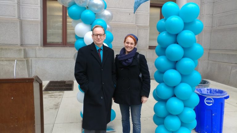 Michael Brossard and Kathryn Wylde speak during a WOAR rally Thursday at Philadelphia City Hall.  (Tom MacDonald/ WHYY)