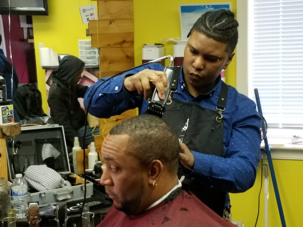 Delaware's master barber Lina Rosser shapes up her client in her Wilmington barber shop. (Andrea Gibbs/ WHYY)