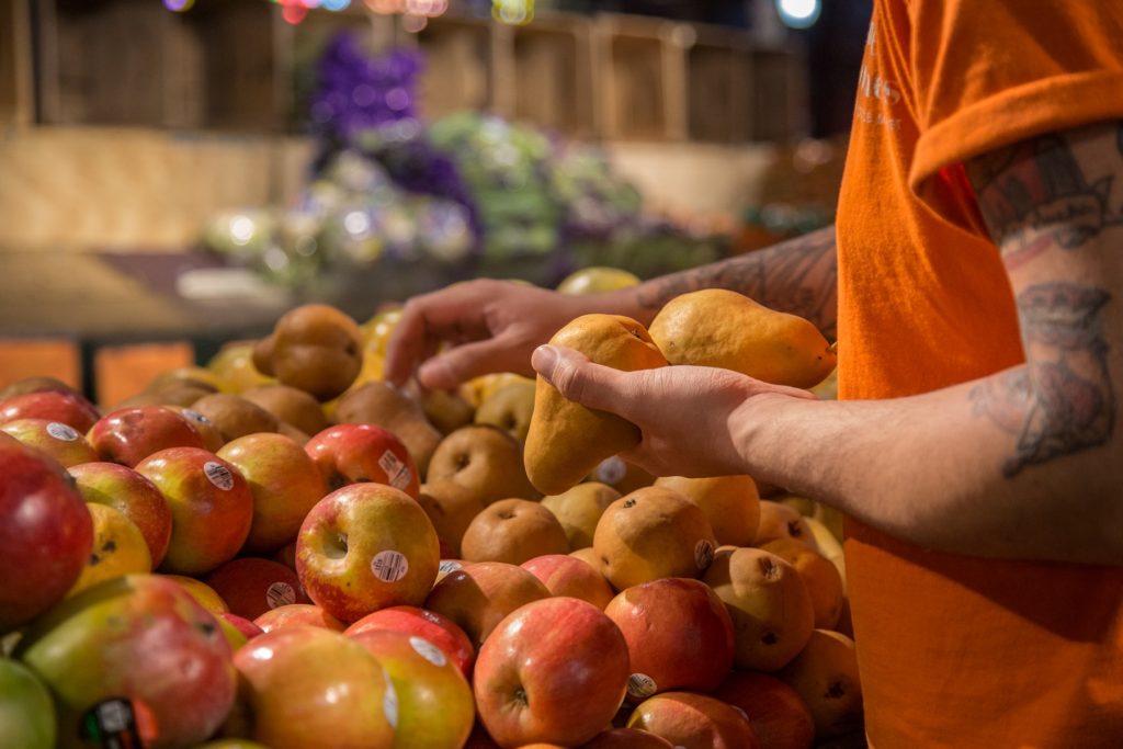 2018 04 27-e cohen-iovineproduce-viewfinders-26 Alex Veal, 28, stacks some pears at Iovine Brothers produce store in Reading Terminal Market.