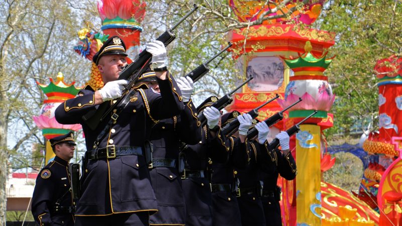 The Philadelphia Police and Fire Honor Guard fire a rifle salute in honor of fallen officers and firefighters. (Emma Lee/WHYY)