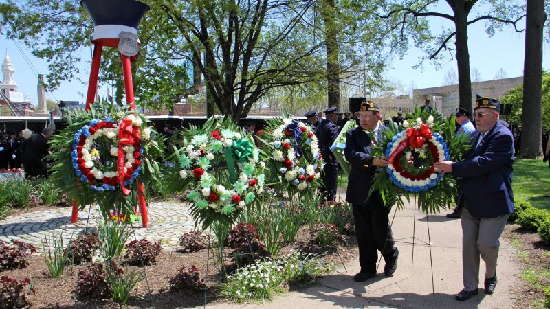 Civic organizations surround the Living Flame Memorial with wreaths in honor of Philadelphia police officers and firefighters who died in the line of duty. (Emma Lee/WHYY)