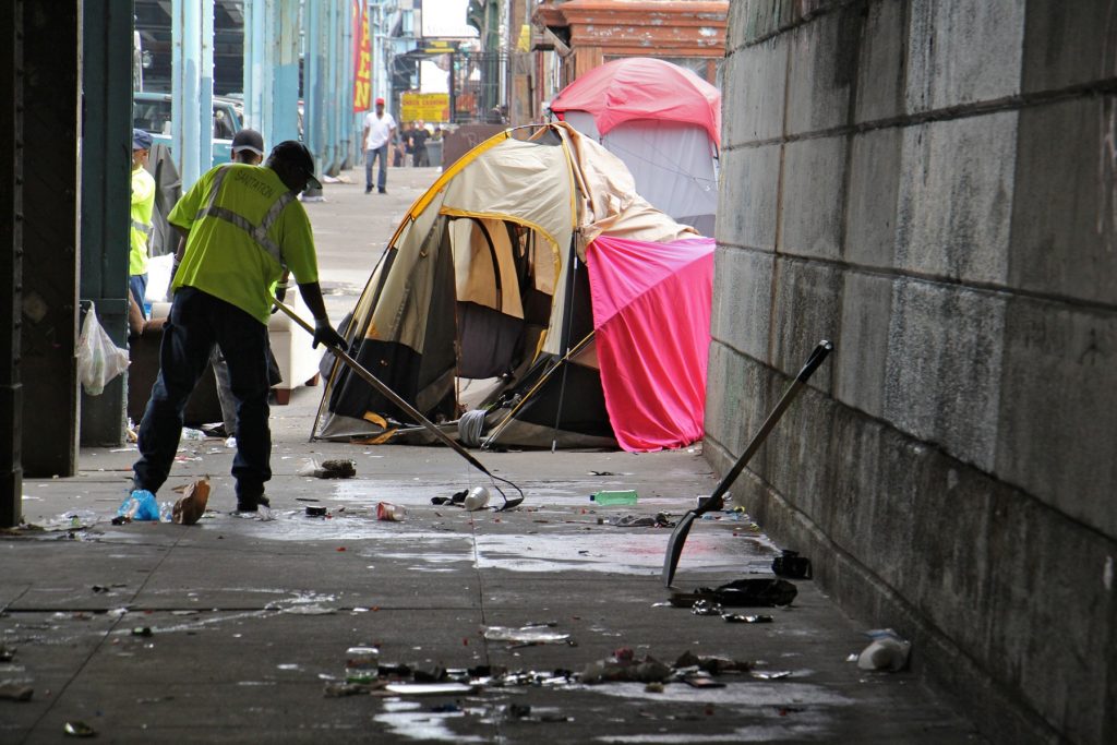 2018 05 04-e lee-philadelphia kensington avenue-heroin camp cleanup Sanitation workers clear away mounds of garbage from a heroin encampment at Lehigh and Kensington avenues. (Emma Lee/WHYY)