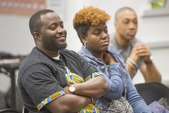 Audience members listen to speakers discuss the legacy of Malcolm X. (Jonathan Wilson for WHYY)