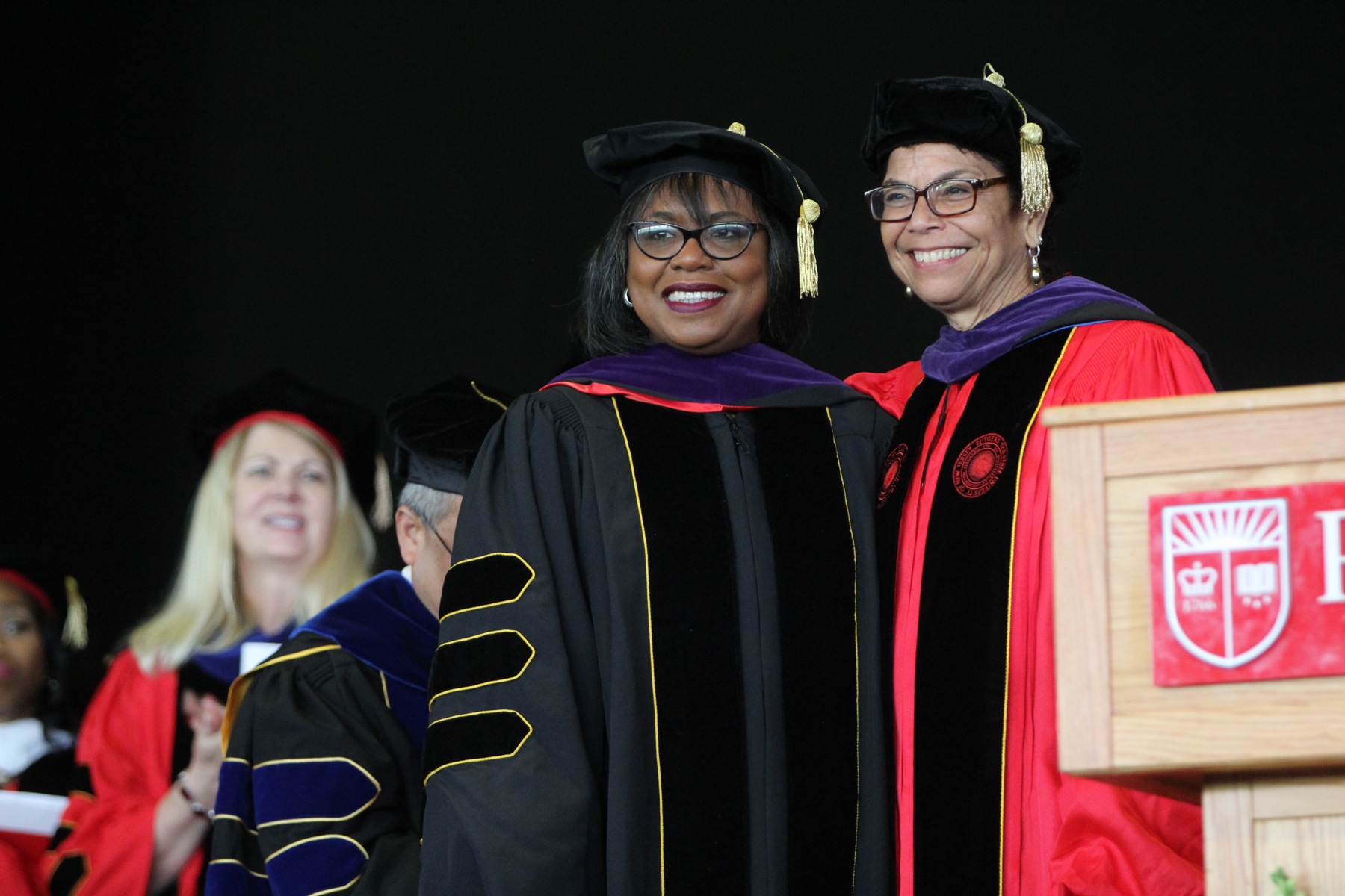 Anita Hill (center) receives an honorary doctor of laws degree from Rutgers Law School Chancellor Phoebe Haddon during a commencement ceremony in Camden.