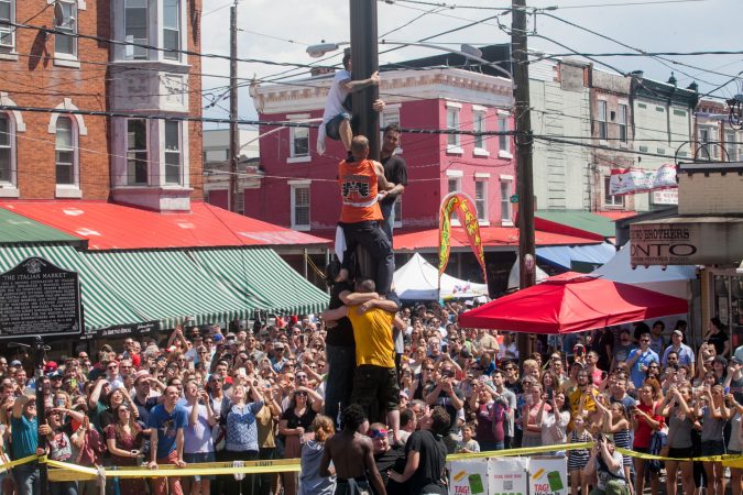 File - Team South Philly made another attempt at ascending the grease pole Sunday at the Italian Market Festival. (Brad Larrison for WHYY)