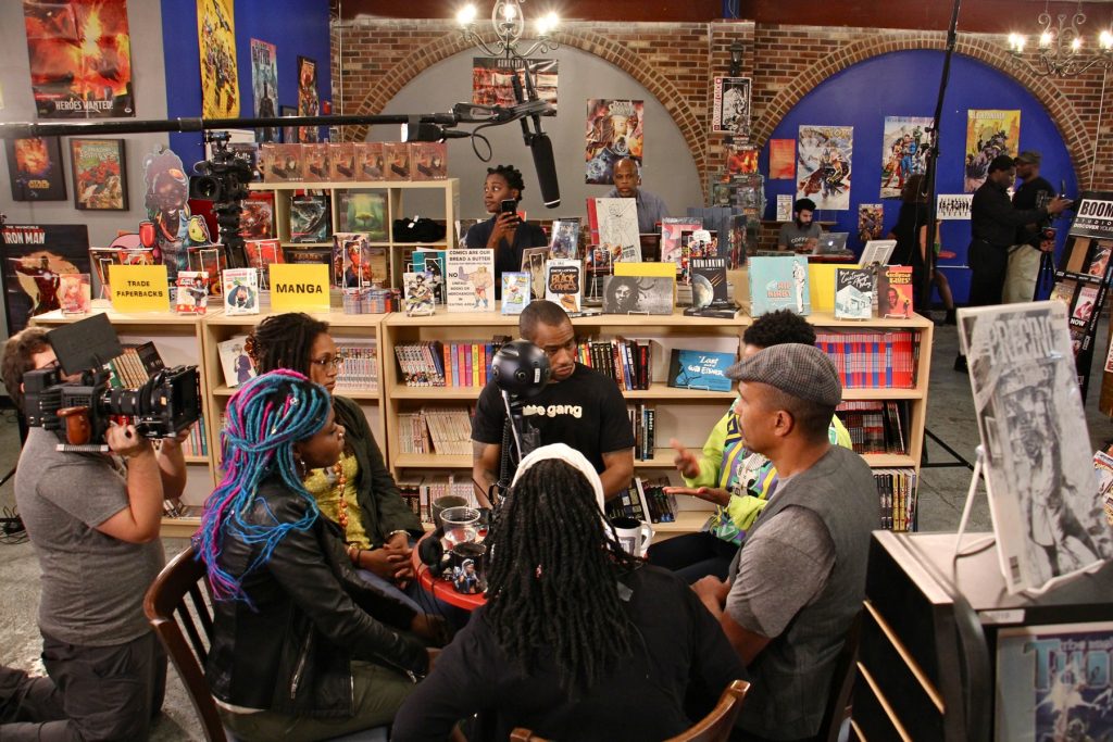 2018 05 29-e lee-kensington amalgam comics Black coffee shop owners gather for a live-streamed conversation about retail racism and supporting black businesses at Amalgam Comics and Coffeeshop in Kensington. Participating are (clockwise from left) Amalgam owner Ariell Johnson, owner of Franny Lou's Porch Blew MaryWillow, activist Mark Lamont Hill, Shantrell P. Lewis of Shoppe Black, Keba Konte of Red Bay Coffee, and activist Pam Africa.
