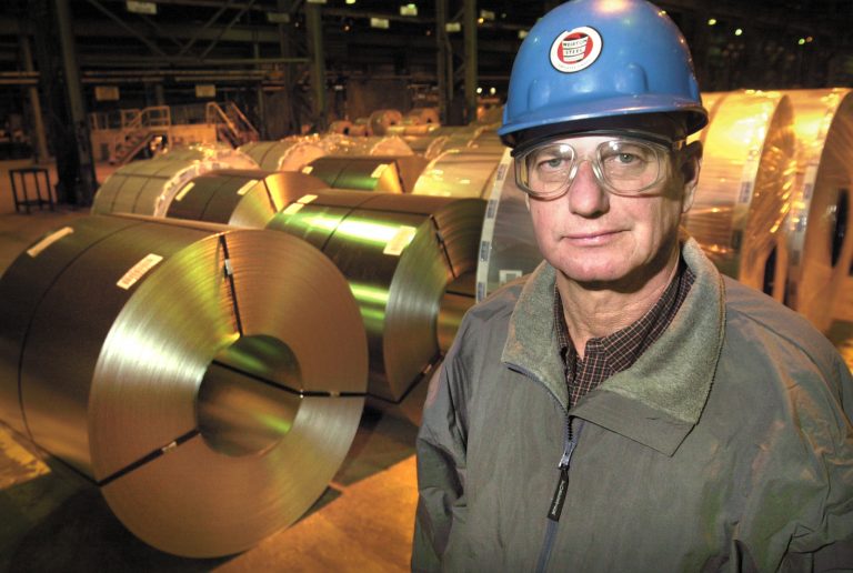 In this file photo, former Independent Steelworkers Union President, Walter Bish, of Weirton, W.Va., and a retired steelworker stands near steel coils located at Weirton Steel plant in Weirton, Thursday, Jan. 8, 2004.  In 1984, Weirton Steel Corp. created a labor legacy, becoming the first major manufacturer and the largest company in America to be owned 100 percent by employees. Its early success inspired United Airlines, Avis and Polaroid, among others, to adopt Employee Stock Ownership Plans. Today, Wawa participates in the little-known program.  (Scott McCloskey/AP Photo)