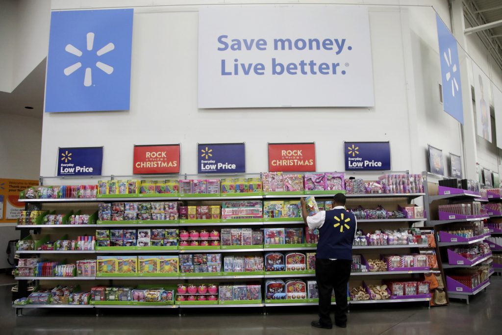 Future of Work-Changing Retail In this Thursday, Nov. 9, 2017, photo, Walmart employee Kenneth White scans items while conducting an exercise during a Walmart Academy class session at the store in North Bergen, N.J. (Julio Cortez/AP Photo)