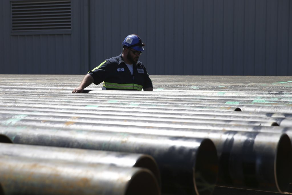 Trump Trade William Hampton walks between steel pipes at the Borusan Mannesmann plant in Baytown, Texas, Monday, April 23, 2018. (AP Photo/Loren Elliott)
