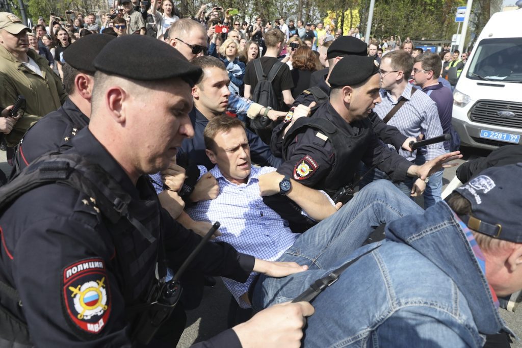 Russian police carrying a struggling opposition leader Alexei Navalny, center, at a demonstration against President Vladimir Putin in Pushkin Square in Moscow, Russia, Saturday, May 5, 2018. Thousands of demonstrators denouncing Putin's upcoming inauguration into a fourth term gathered Saturday in the capital's Pushkin Square. (AP Photo)