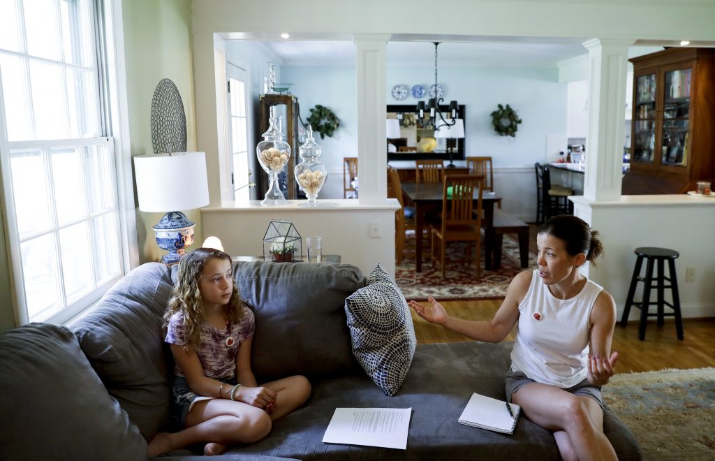 Sandy Nissenbaum, Nora Nissenbaum In this Thursday, May 3, 2018 photo, Sandy Nissenbaum, (right), and her daughter, Nora Nissenbaum, 12, talk during an interview with The Associated Press in Wayne, Pa. The case of a suburban Philadelphia boy who was quietly allowed to return to class after being accused of making a shooting threat has thrown a spotlight on the hard decisions school authorities must make. Nora Nissenbaum who says the boy bullied her has withdrawn from class for fear of him. (Matt Slocum/AP Photo)