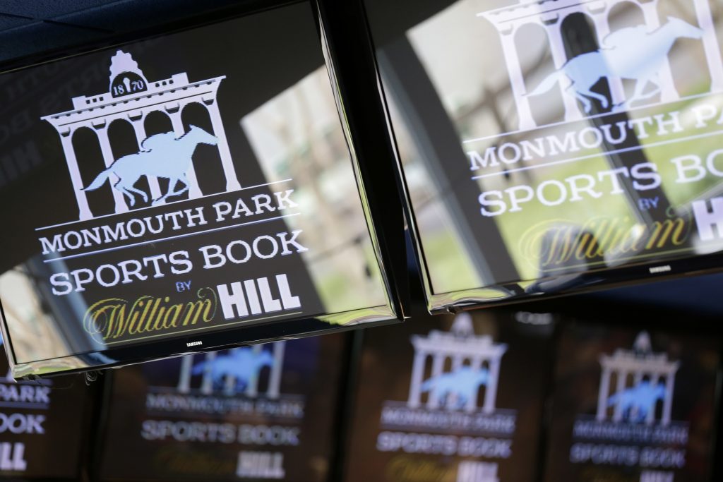 Supreme Court Sports Betting Signs for Monmouth Park are displayed in a bar at the racetrack in Oceanport, N.J., Monday, May 14, 2018. The Supreme Court on Monday gave its go-ahead for states to allow gambling on sports across the nation, striking down a federal law that barred betting on football, basketball, baseball and other sports in most states.