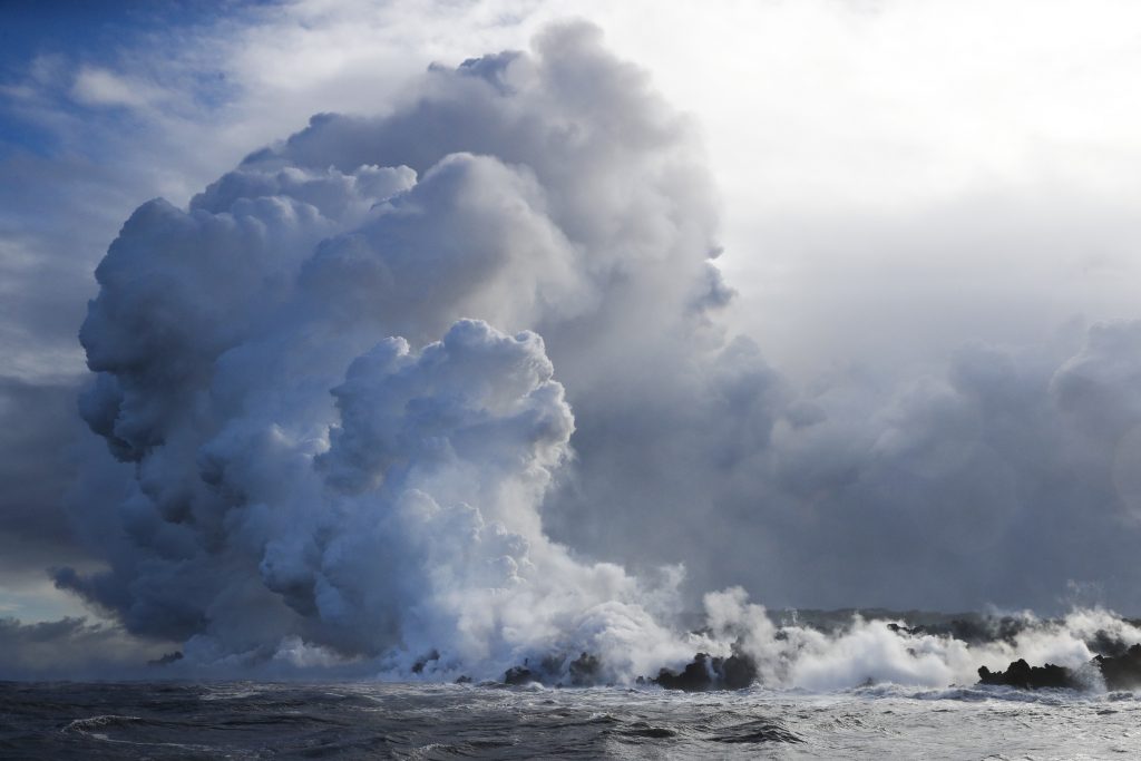 Hawaii Volcano Plumes of steam rise as lava enters the ocean near Pahoa, Hawaii Sunday, May 20, 2018. Kilauea volcano that is oozing, spewing and exploding on Hawaii's Big Island has gotten more hazardous in recent days, with rivers of molten rock pouring into the ocean Sunday and flying lava causing the first major injury