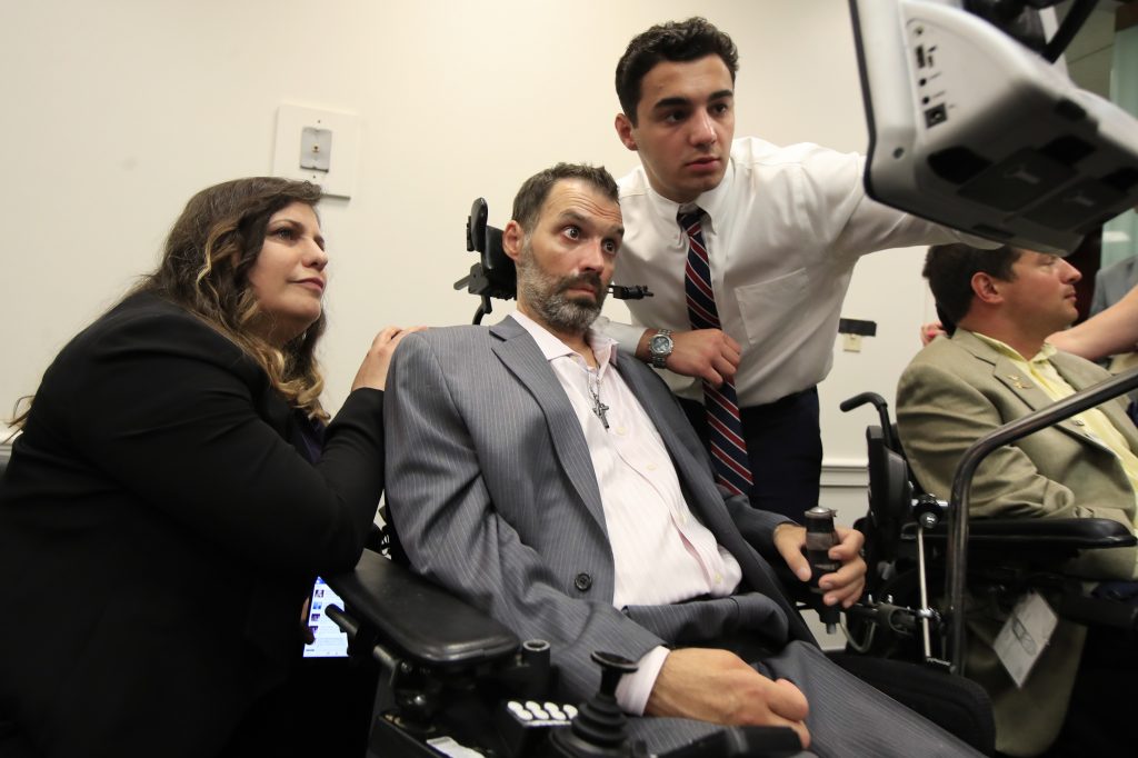 Frank Mongiello, Marilyn Mongiello ALS patient Frank Mongiello communicates with his wife, Marilyn, and his son during a news conference following the passage of the
