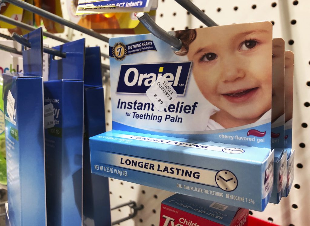 Teething Products Warning Orajel is displayed for sale in a pharmacy in New York Wednesday, May 23, 2018. The US Food and Drug Administration is warning parents about potentially deadly risks of teething remedies that contain a numbing ingredient used in popular brands like Orajel. The agency on Wednesday said it wants manufacturers to stop selling products intended for babies and toddlers because the products contain a drug ingredient that can cause a rare but dangerous blood condition that interferes with normal breathing. (Stephanie Nano/AP Photo)