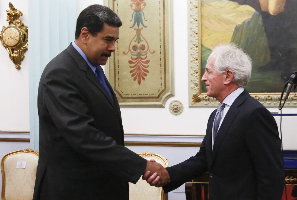 Venezuela US Senator’s Visit In this photo released by the Miraflores Presidential Press Office, Venezuela's President Nicolas Maduro, left, shakes hands with Republican Senator Bob Corker during a meeting at the Miraflores Presidential Palace in Caracas, Venezuela, Friday May 25, 2018. The Chairman of Senate Foreign Relations Committee met with Venezuelan President Nicolas Maduro two days after the embattled socialist leader kicked out the top U.S. diplomat in the country. There was no immediate comment from Republican Senator Bob Corker's office about the nature of the surprise visit. (Miraflores Presidential Press Office via AP)