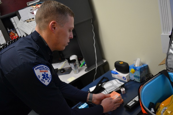 Susquehanna Township EMS director Matt Baily removes naloxone from a supply cabinet. EMS personnel will begin carrying a non-addictive pain drug, keterolac, beginning July 1. (Brett Sholtis/Transforming Health)