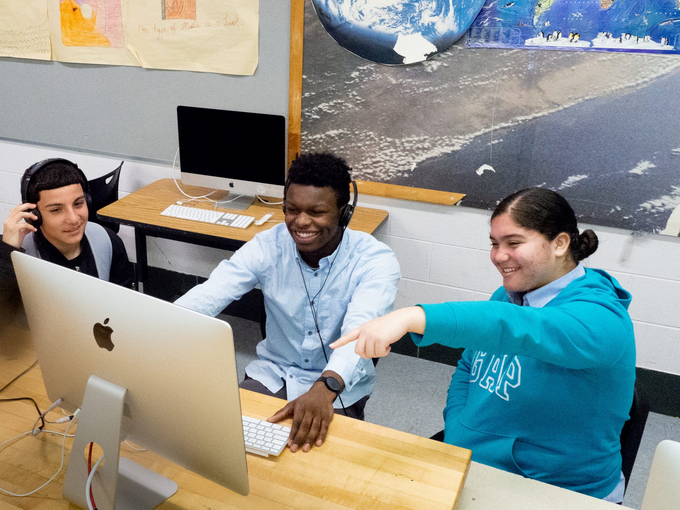 At The LINC High School, students Jose Vasquez, Sevonne Brockington and Anjeline Genao review a video project in the school’s digital lab.