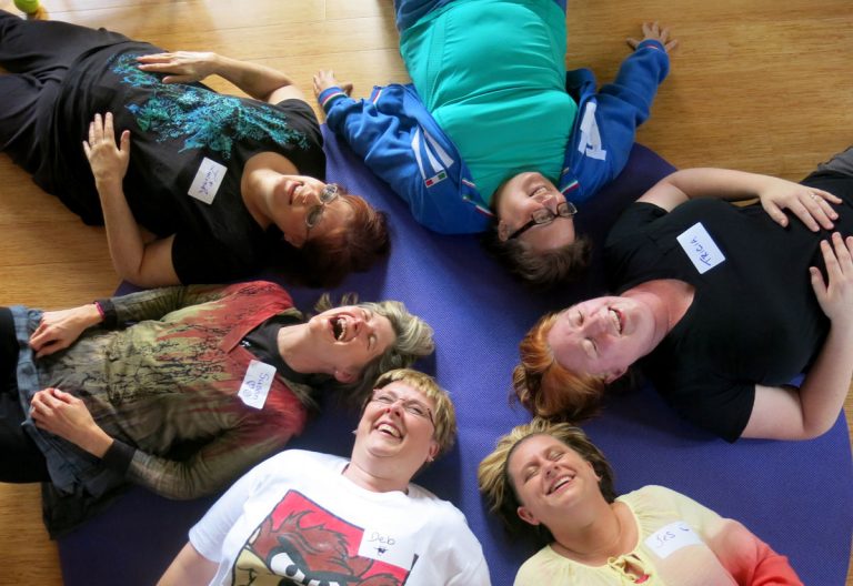 Laughter yoga participants yucking it up for stress relief. (Alexa Fong Drubay)