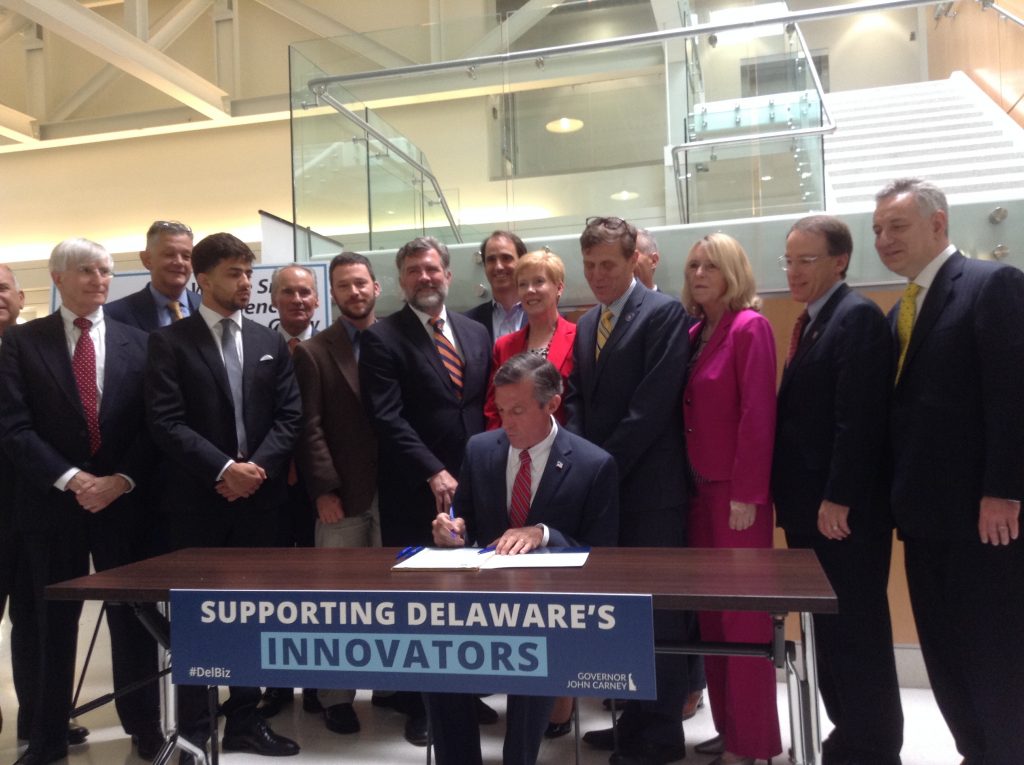 IMG_0511 Gov. John Carney signs legislation that aims to incentivize startup businesses in Delaware. (Zoe Read/WHYY)
