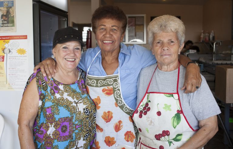 A group of women in the community of Mariana, in Puerto Rico, meet everyday to cook for their neighbors. They say after the storm, the work and camaraderie have eased depression. (Irina Zhorov/WHYY)