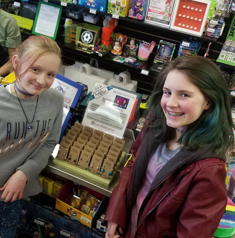 The author's daughters/girlbosses standing in front of their jewelry in MonkeyFish.