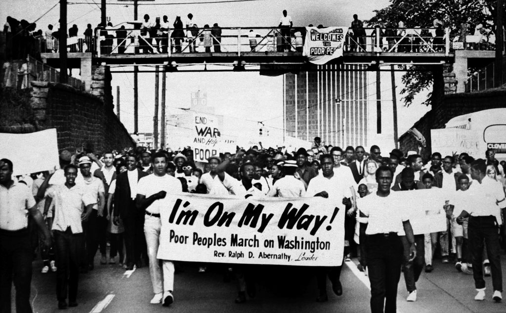 Poor People’s March 1968 Sign-carrying participants march on the southern leg of the Poor People's Campaign May 10, 1968, in Atlanta. (AP file photo)