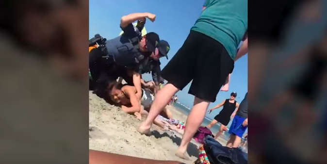 Screen Shot 2018-05-30 at 4.44.06 AM Screenshot of the YouTube video showing Wildwood Police striking the woman before officers handcuffed her. (YouTube)