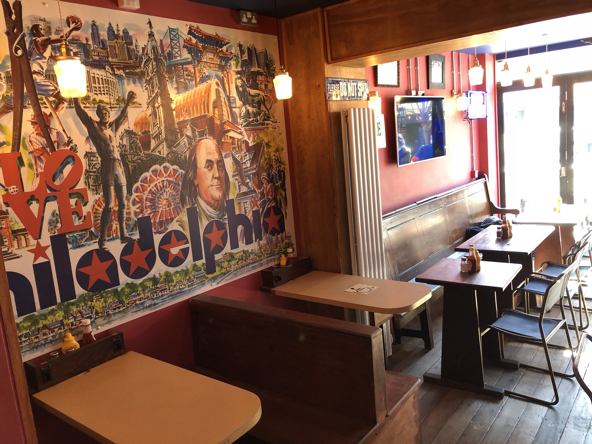 A Philadelphia collage on the wall of Passyunk Avenue, a Philly-themed dive bar in London.