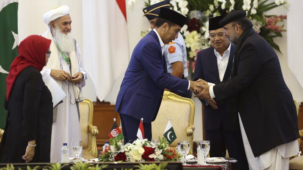 Scholars from Afghanistan, Pakistan and Indonesia attended a conference on Friday to discuss stability in Afghanistan. Indonesian President Joko Widodo (center) shakes hands with Qibla Ayaz, chairman of Pakistan’s Council of Islamic Ideology. Scholars from Afghanistan, Pakistan and Indonesia attended a conference on Friday to discuss stability in Afghanistan. Indonesian President Joko Widodo (center) shakes hands with Qibla Ayaz, chairman of Pakistan's Council of Islamic Ideology. (Dita Alangkara/AP)