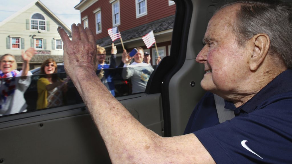 In this May 20 photo provided by the office of George H.W. Bush, the former president waves to supporters as his motorcade arrives in Kennebunkport, Maine. A Bush spokesman said the nation's 41st president was eager to get to Maine after enduring his wife's death and then being hospitalized shortly after that with a blood infection.