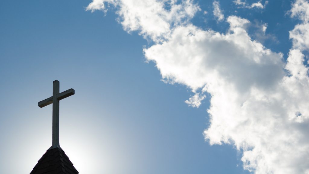An old church steeple backlit by a low setting sun. (wwing/Getty Images) 