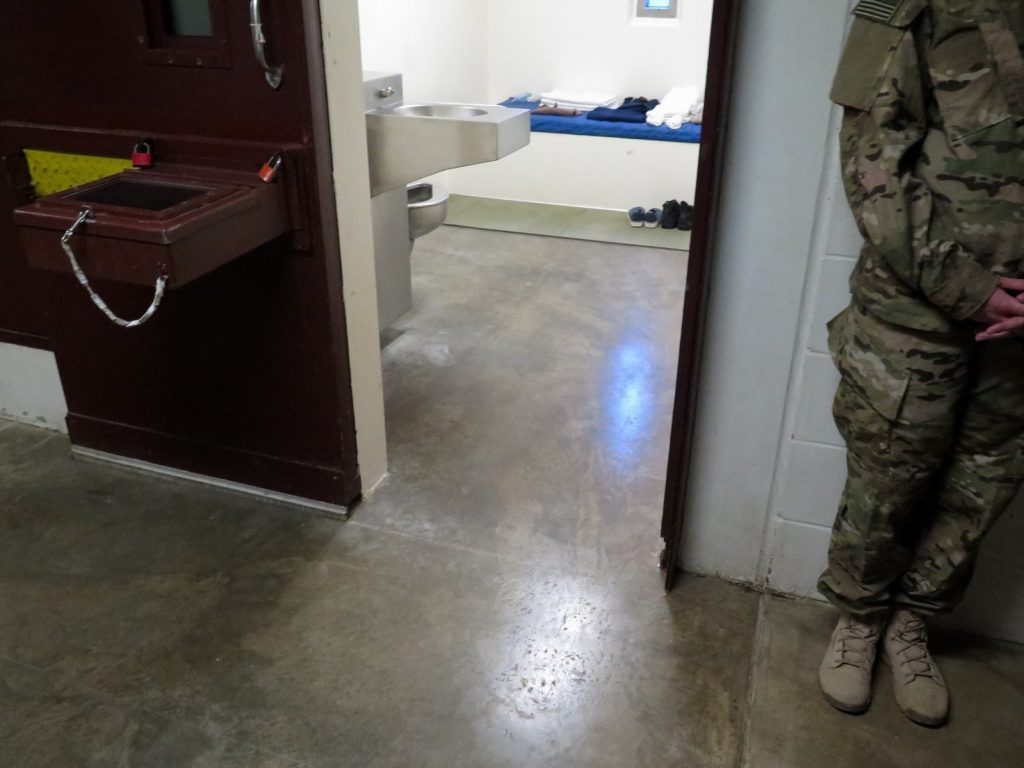 A U.S. military service member stands outside a prison cell at Camp 5. (Photo reviewed and cleared by U.S. military.) A U.S. military service member stands outside a prison cell at Camp 5. (Photo reviewed and cleared by U.S. military. David Welna/NPR)