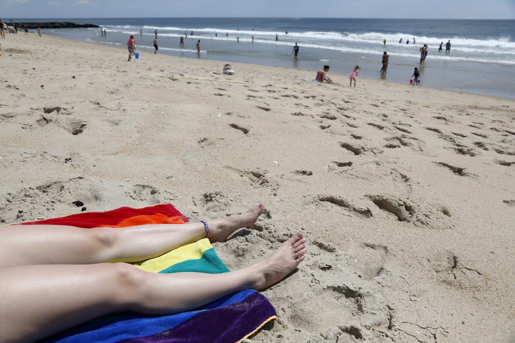 New Jersey Beaches a person tanning on the Jersey Shore