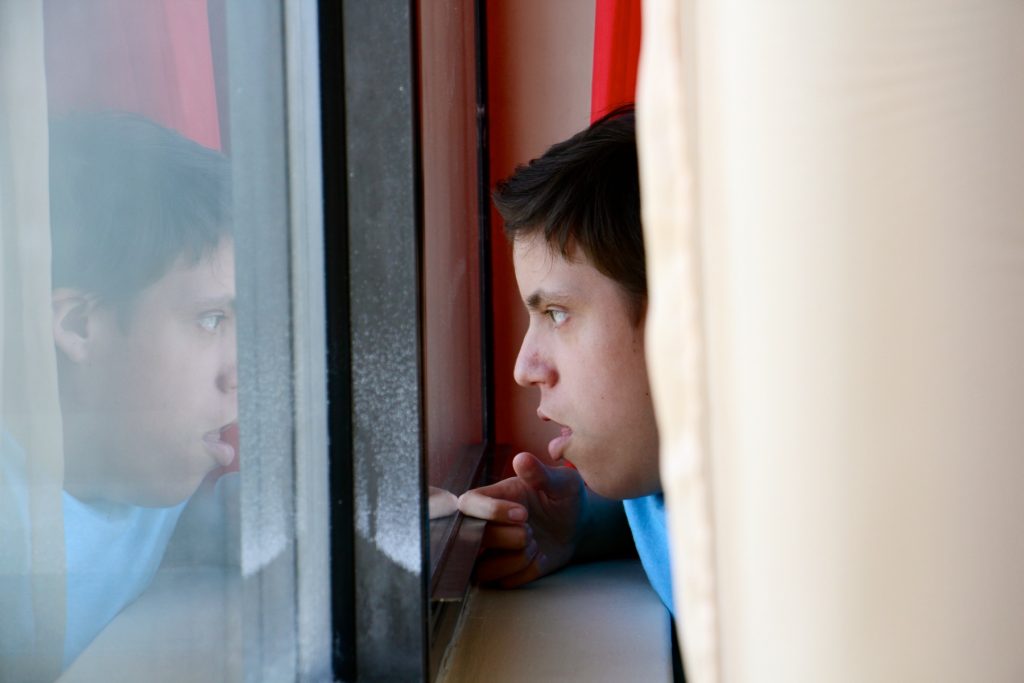 2018 05 08-e lee-philadelphia harrison homes-housing for puerto rican families after hurricane maria Luis Angel Chaparro Crespo, 16, watches the trains go by from the window of his apartment on the sixth floor of the Harrison Homes in North Philadelphia.