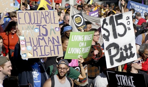 In this April 14, 2016, file photo, union organizers, students, and supporters for a $15 an hour wage march through the Oakland section of Pittsburgh. (Keith Srakocic/AP Photo, File)