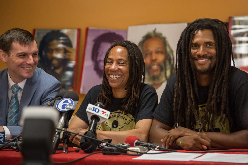 06 19 2018-ecohen-debbie africa-10 Debbie Africa sits with her lawyer, Brad Thomson (left), and her son Michael Africa Jr (right) as she makes her first public appearance since being released from prison after 39 years and 10 months of incarceration on June 19th 2018. (Emily Cohen for WHYY)
