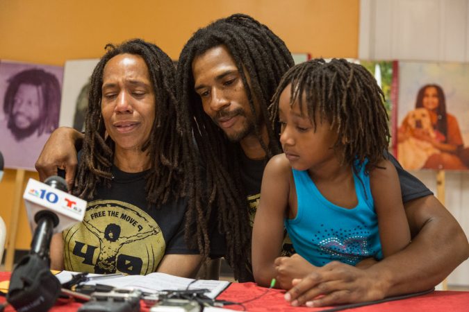 Debbie Africa is comforted by her son, Michael Africa Jr., as she makes her first public appearance since being released from prison after 39 years and 10 months of incarceration on Tuesday. (Emily Cohen for WHYY)