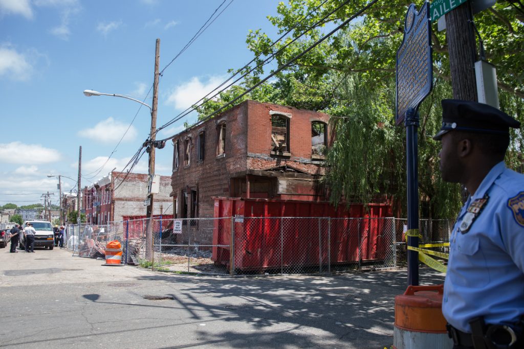 060418_building_collapse_brewerytown_llazarski_01 A police officer secures the block as investigators survey a demolition site that turned deadly at the corner of Jefferson and Bailey Streets in North Philadelphia on June 04, 2018. (Lindsay Lazarski/WHYY)