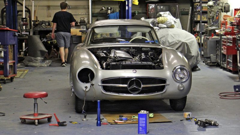 A classic car gets a sprucing up at Simeone Foundation Automotive Museum in South Philadelphia. Nearly all of the cars in the collection are driveable. (Emma Lee/WHYY)